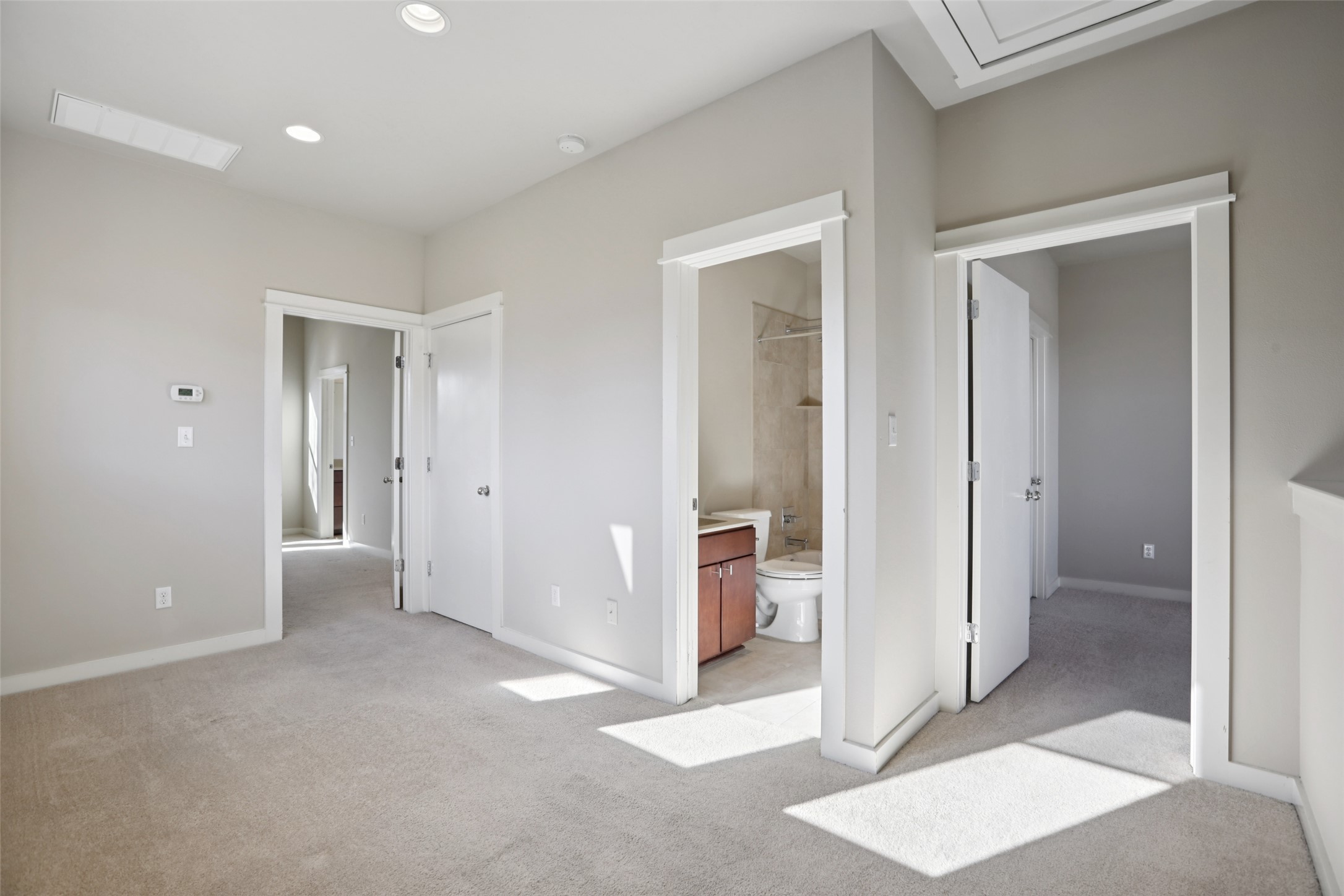 1123 Blair Way Austin, TX 78704 - Photo 16 of 30 Unfurnished bedroom with light colored carpet, ensuite bath, and recessed lighting