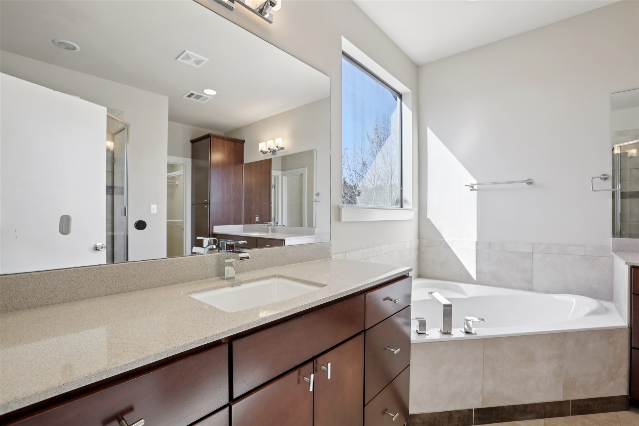 1123 Blair Way Austin, TX 78704 - Photo 21 of 30 Full bathroom with a shower stall, vanity, a bath, and light tile patterned flooring