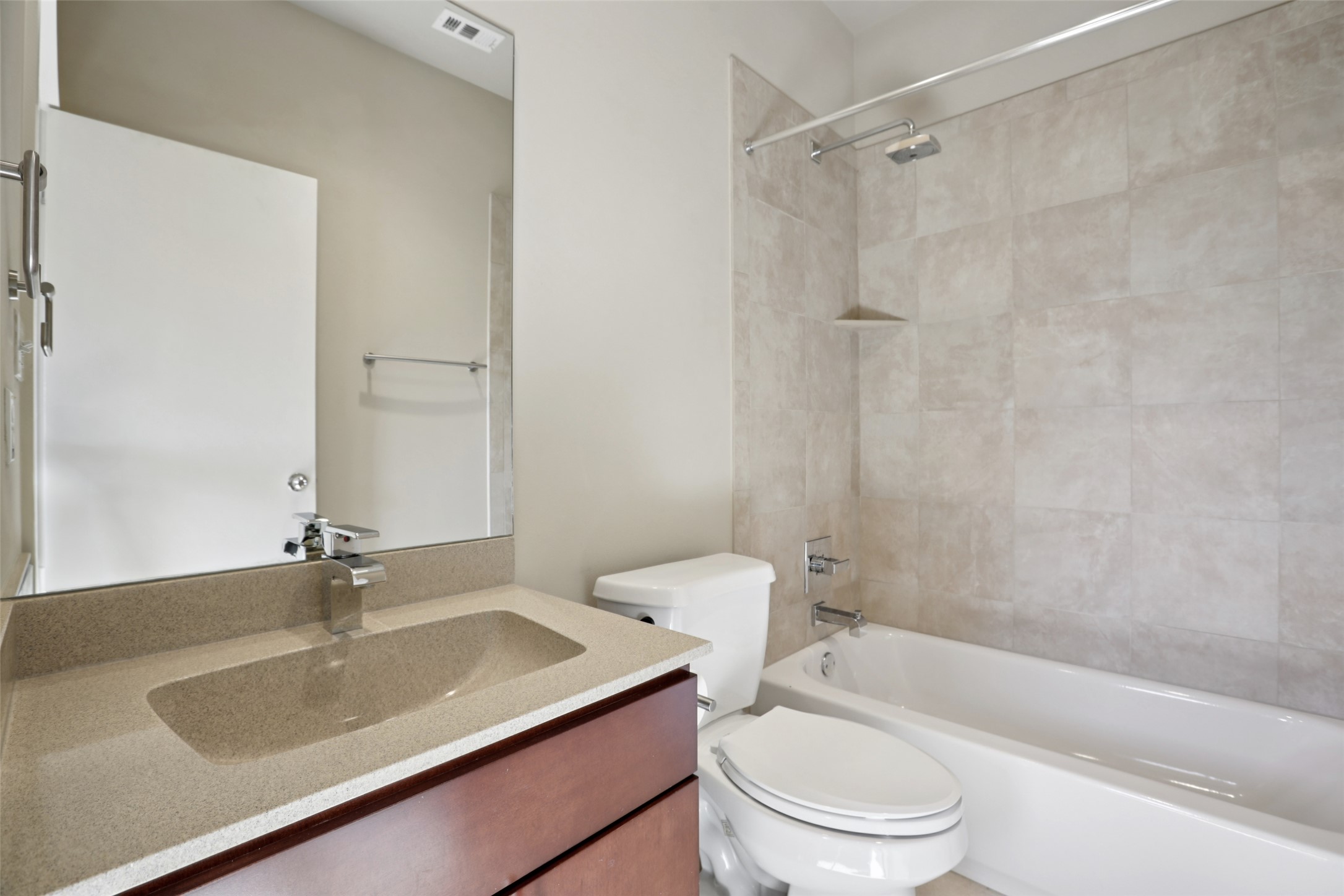 1123 Blair Way Austin, TX 78704 - Photo 22 of 25 a bathroom with a granite countertop sink toilet a mirror and shower