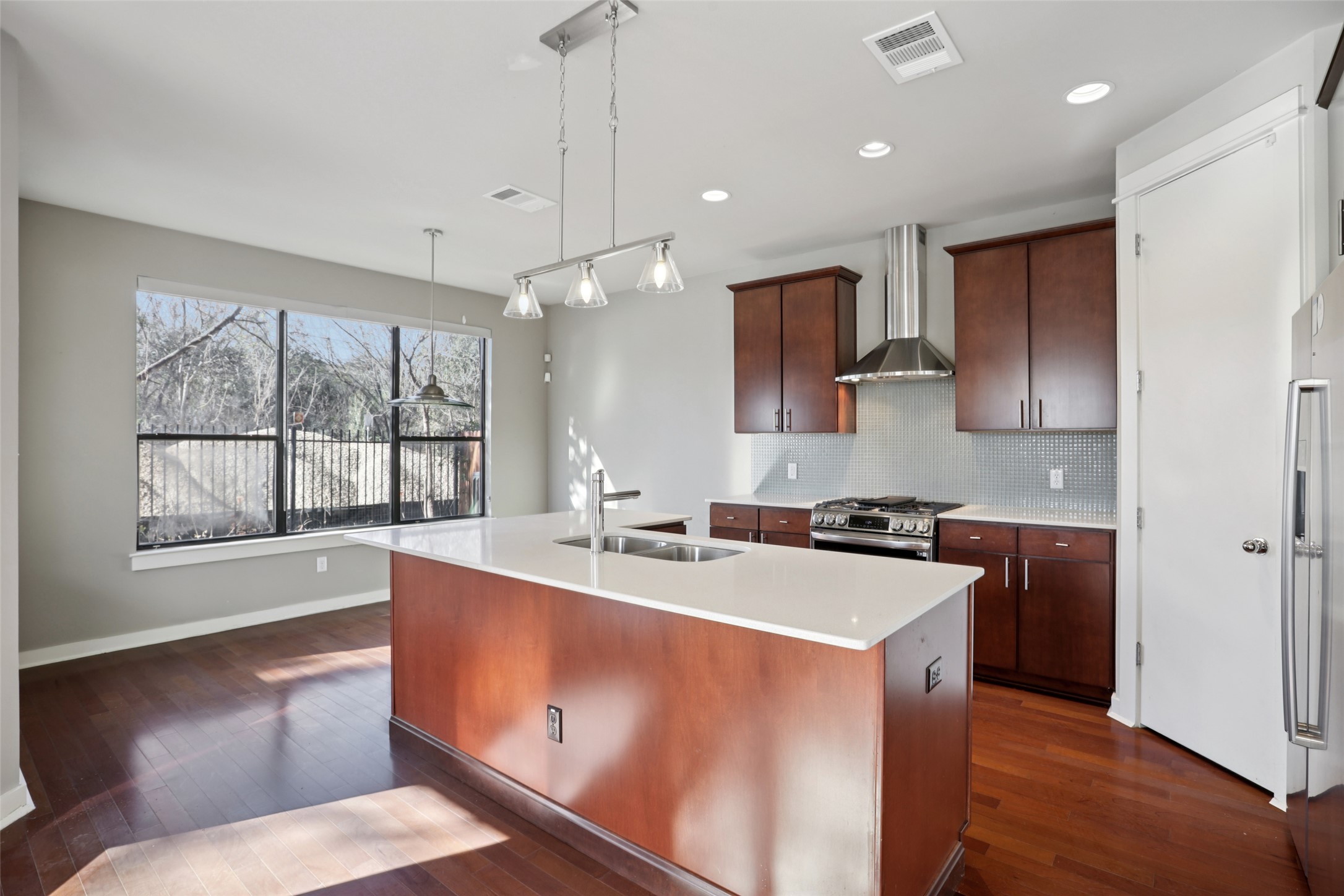 1123 Blair Way Austin, TX 78704 - Photo 5 of 25 a kitchen that has a sink a stove and a wooden floor