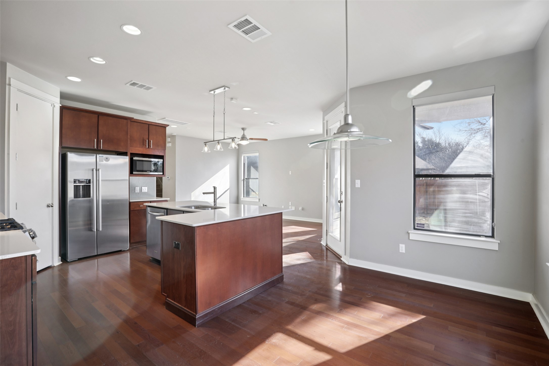1123 Blair Way Austin, TX 78704 - Photo 6 of 25 a kitchen with stainless steel appliances granite countertop a refrigerator a sink dishwasher a oven and a dining table with wooden floor