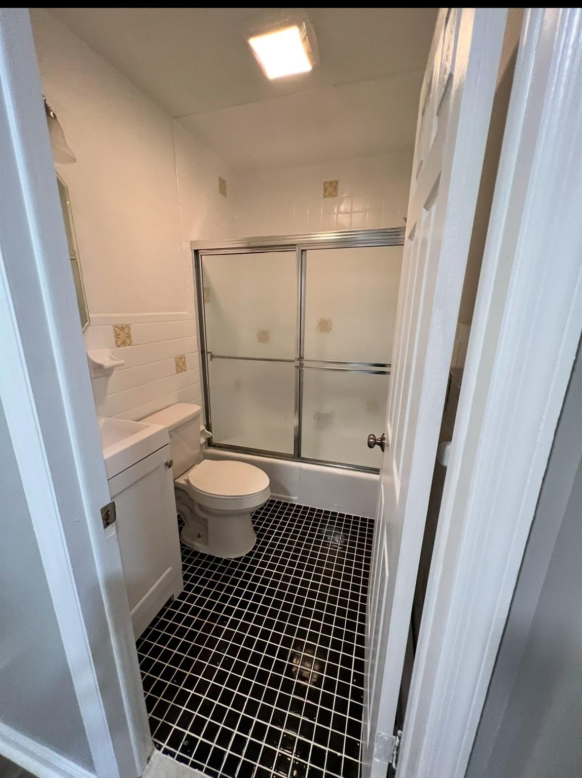 2410 Boston Post Road Larchmont, NY 10538 - Photo 17 of 26 Full bathroom featuring toilet, enclosed tub / shower combo, and vanity