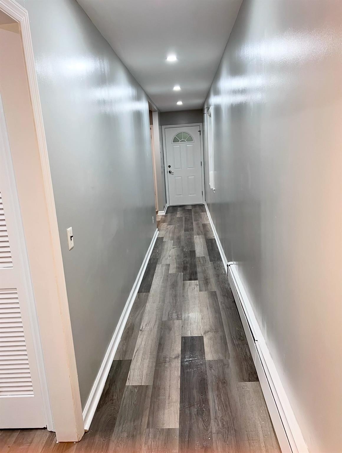 2410 Boston Post Road Larchmont, NY 10538 - Photo 25 of 26 Hall featuring baseboard heating and wood-type flooring