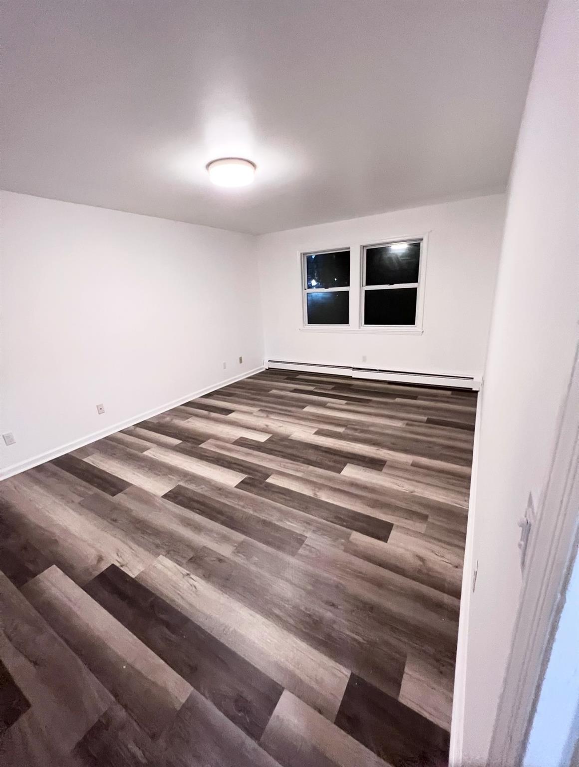2410 Boston Post Road Larchmont, NY 10538 - Photo 26 of 26 Empty room featuring dark hardwood / wood-style flooring