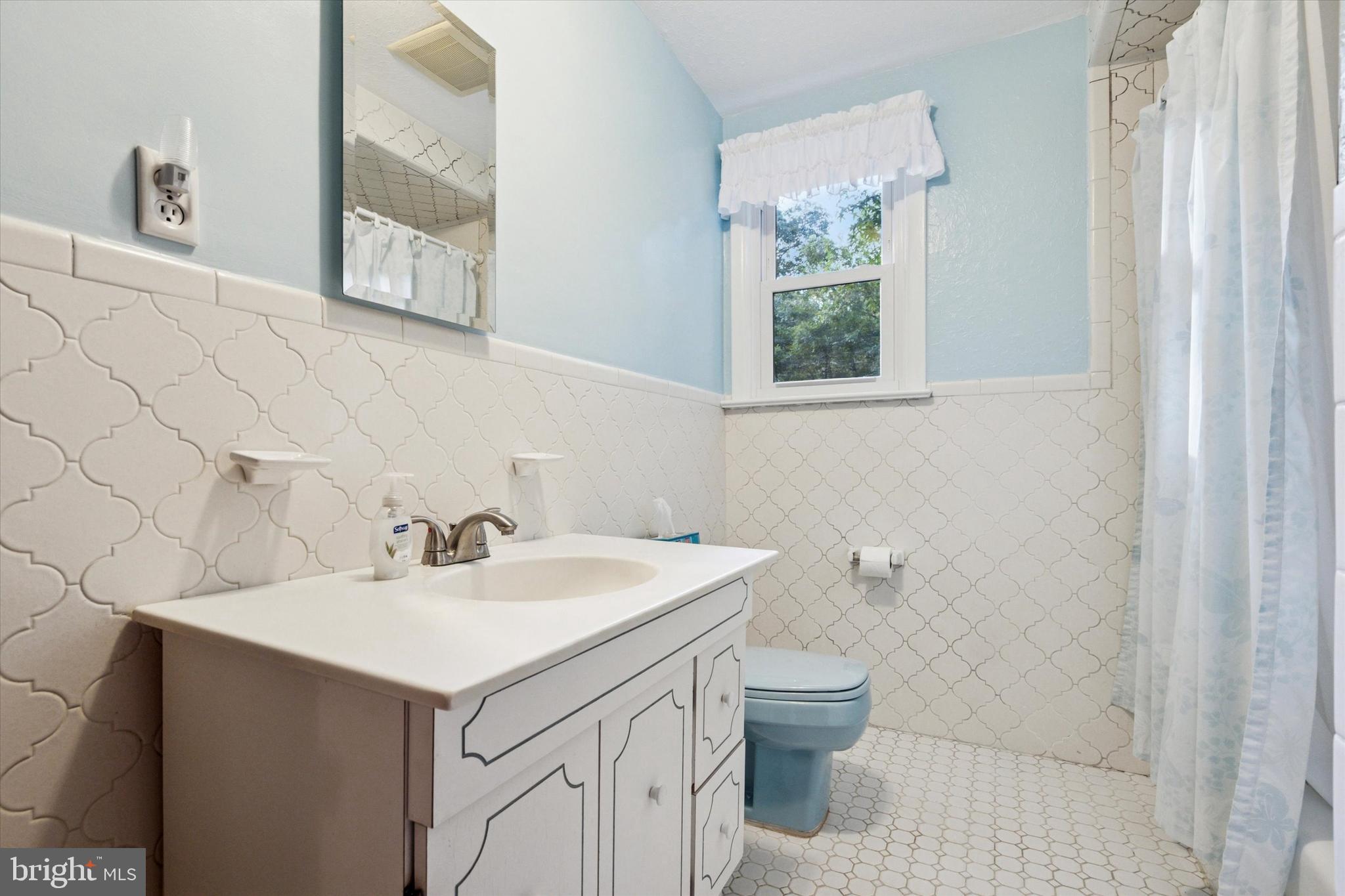 1742 Paradise Lane Bensalem, PA 19020 - Photo 20 of 25 a bathroom with a sink a toilet and a mirror