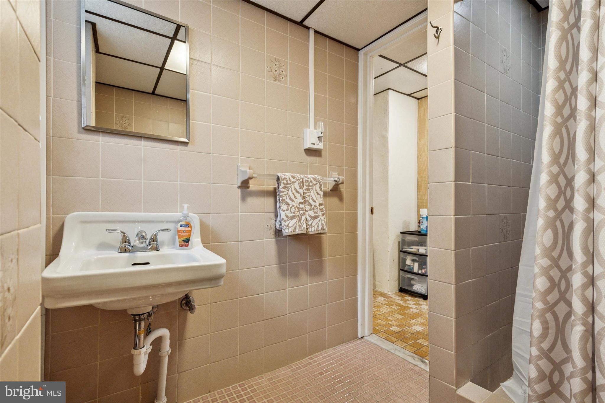 1742 Paradise Lane Bensalem, PA 19020 - Photo 21 of 25 a bathroom with a sink and mirror