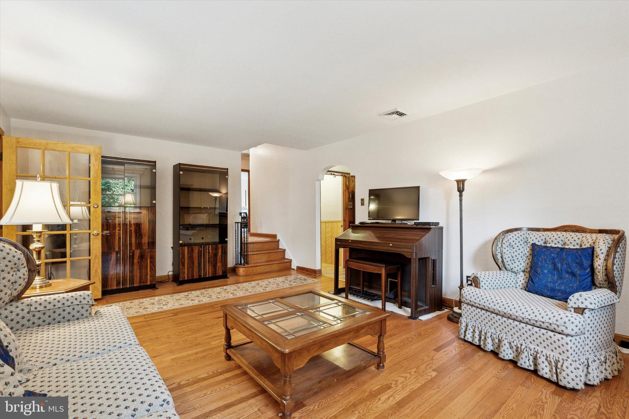 1742 Paradise Lane Bensalem, PA 19020 - Photo 3 of 25 a living room with furniture a flat screen tv and a fireplace