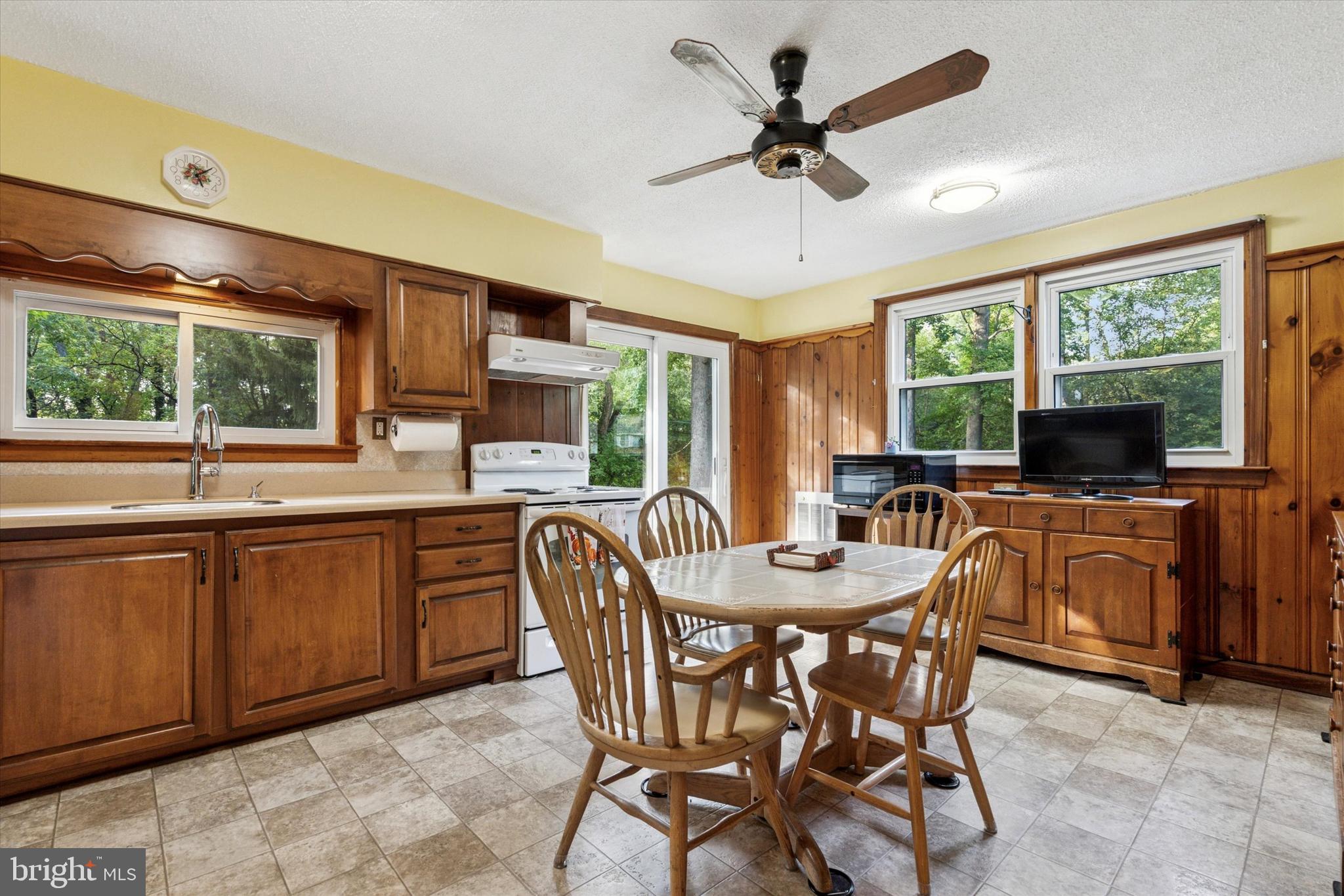 1742 Paradise Lane Bensalem, PA 19020 - Photo 6 of 25 a dining room with furniture a flat screen tv and large windows