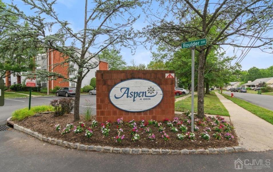 40 Boulder Drive Edison, NJ 08817 - Photo 1 of 23 a view of a park with a bench and large trees