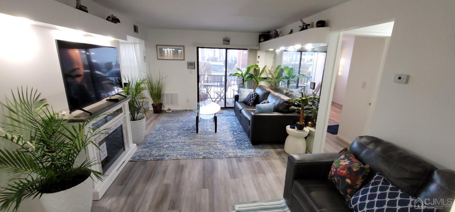 40 Boulder Drive Edison, NJ 08817 - Photo 22 of 23 a living room with furniture and a flat screen tv