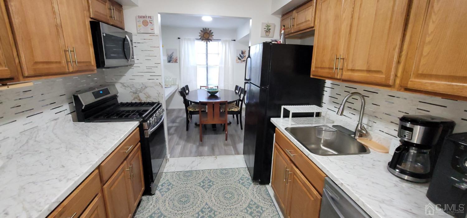 40 Boulder Drive Edison, NJ 08817 - Photo 4 of 23 a kitchen with refrigerator and cabinets