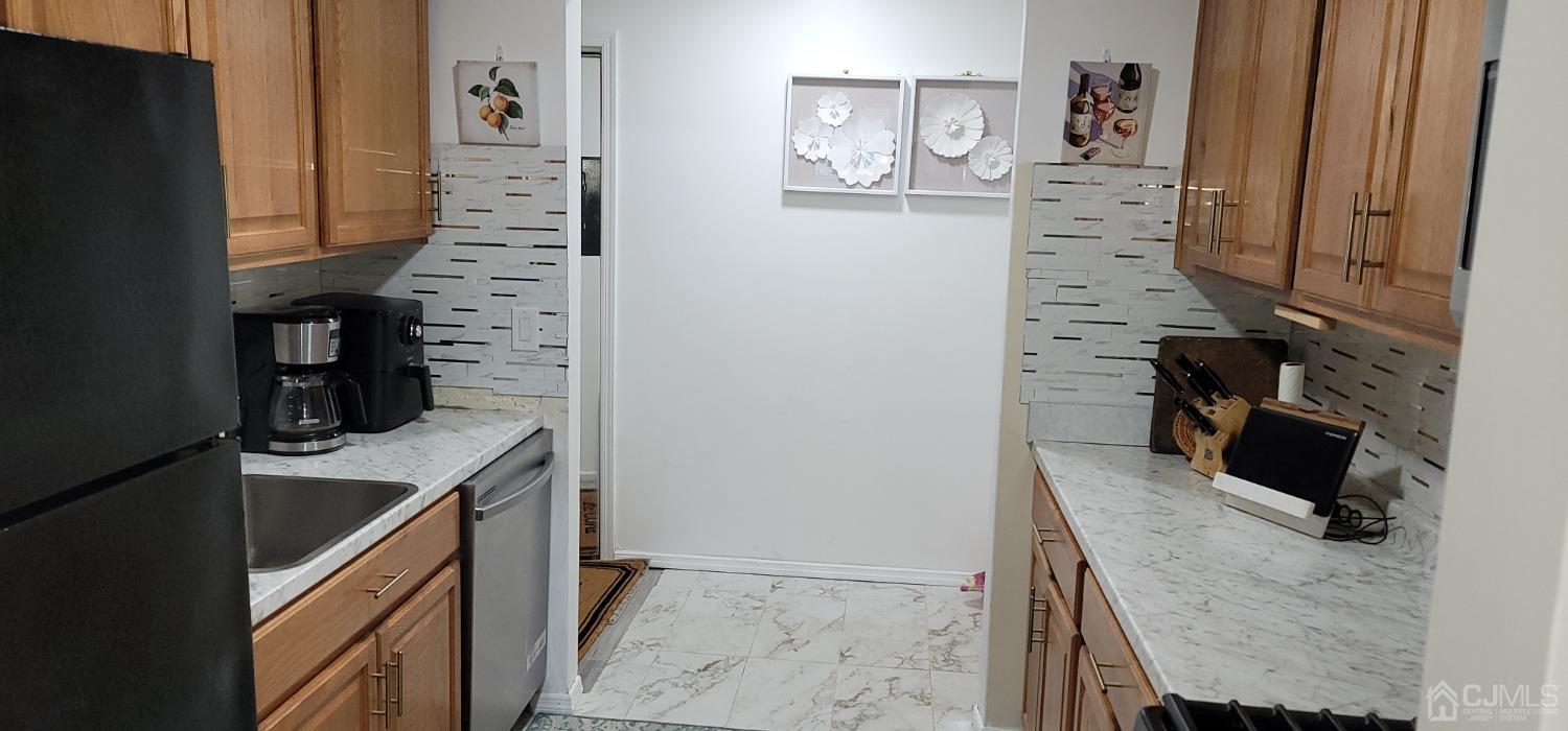 40 Boulder Drive Edison, NJ 08817 - Photo 7 of 23 a kitchen with stainless steel appliances a refrigerator and a stove top oven