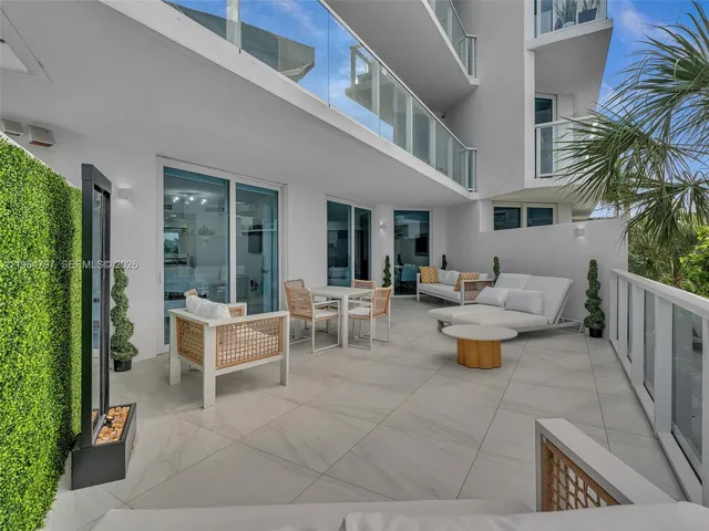 a view of a palm plant from a balcony