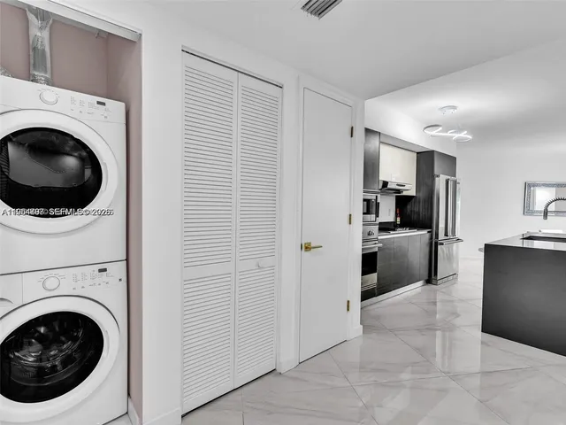 a view of a kitchen with washer and dryer