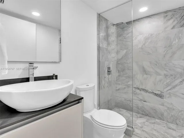 a bedroom with a bed and a ceiling fan