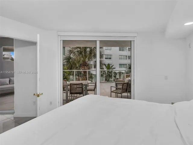 a view of a roof deck with couches potted plants and wooden floor
