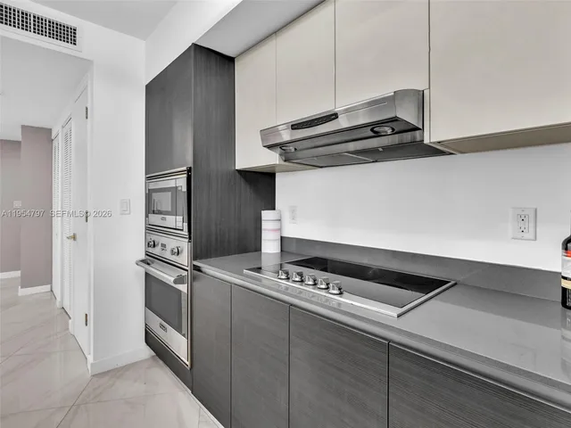 a kitchen with stainless steel appliances a sink a stove and a refrigerator