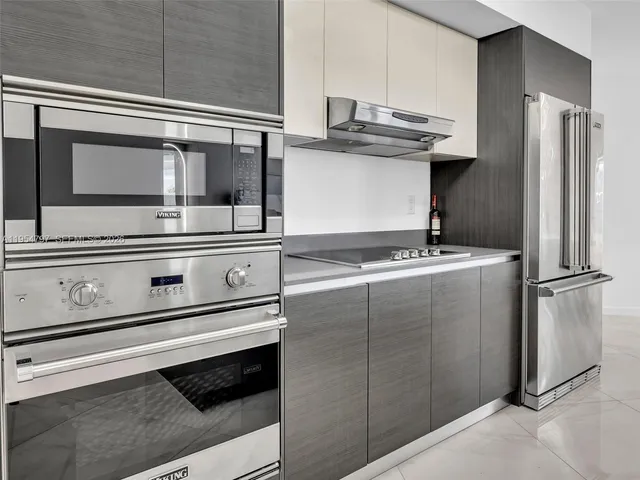 a view of a kitchen with a stove and a refrigerator