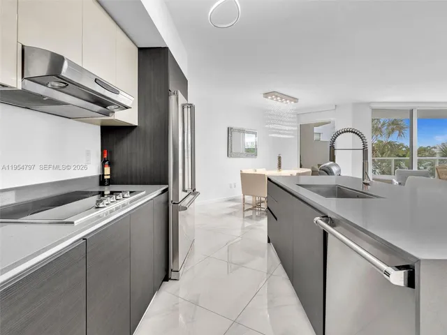a kitchen with a sink and a stove top oven