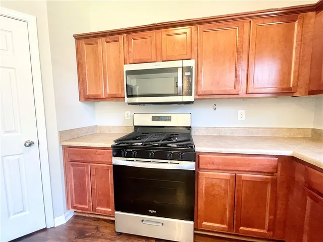 a kitchen with wooden cabinets and a stove top oven