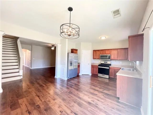 a view of kitchen with sink microwave refrigerator and stove