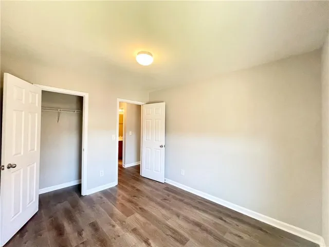 a bathroom with a double vanity sink toilet mirror and shower
