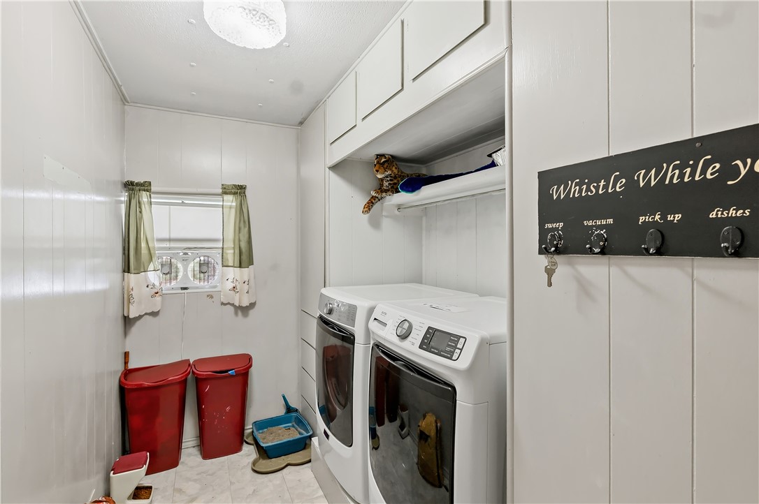 10084 Fm 831 Buffalo, TX 75831 - Photo 19 of 50 a utility room with dryer washer and a view of living room