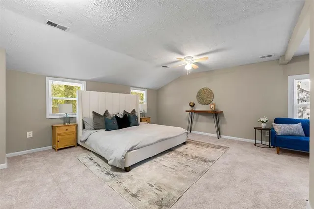 a bedroom with a bed and a table