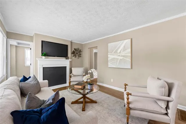 a living room with furniture a fireplace and a flat screen tv