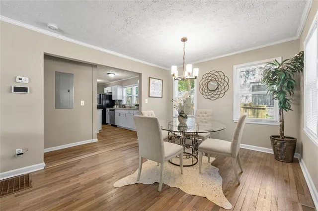 a view of a dining room with furniture wooden floor and chandelier