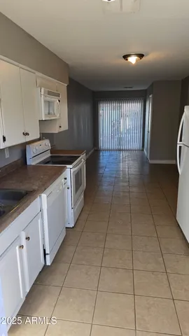 a kitchen with a stove cabinets and a counter top space