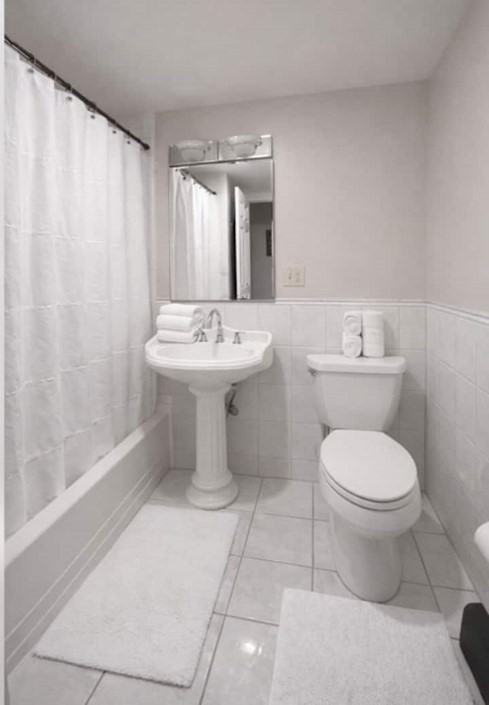 749 Worcester Street Wellesley, MA 02481 - Photo 13 of 17 a bathroom with a toilet sink and mirror