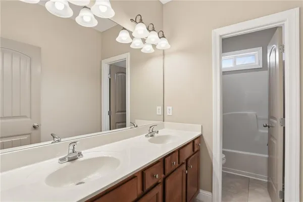 a bathroom with a sink a vanity and a mirror