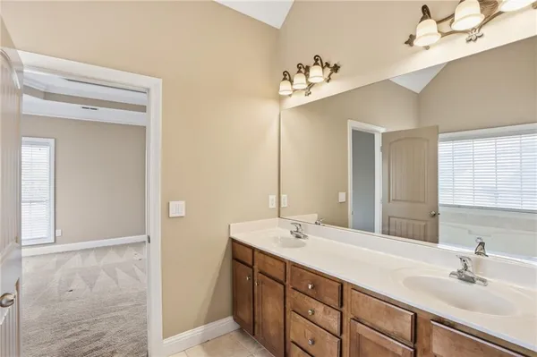 a bathroom with a sink vanity and mirror