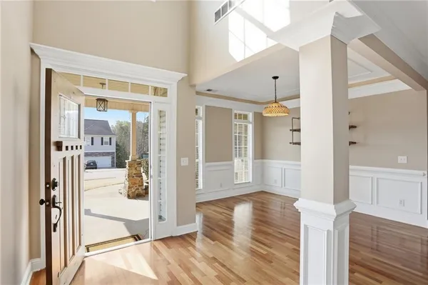 a view of a hallway view with wooden floor and dining room view