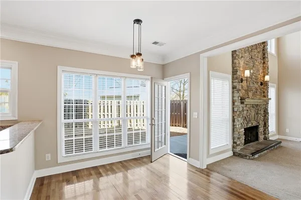 a view of an empty room with a fireplace and a window