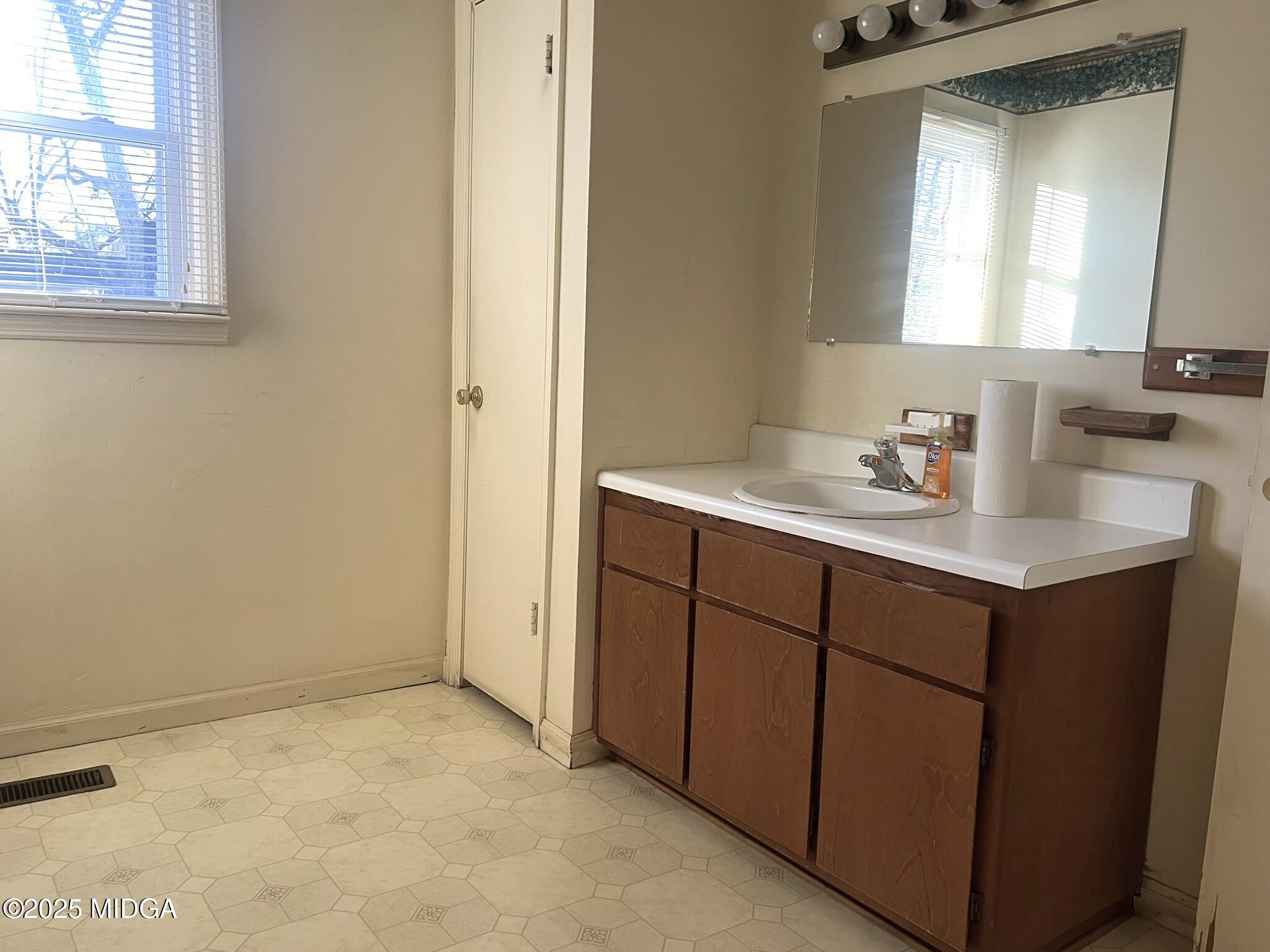 3640 South Walden Road Macon, GA 31216 - Photo 15 of 21 a bathroom with a sink vanity and mirror