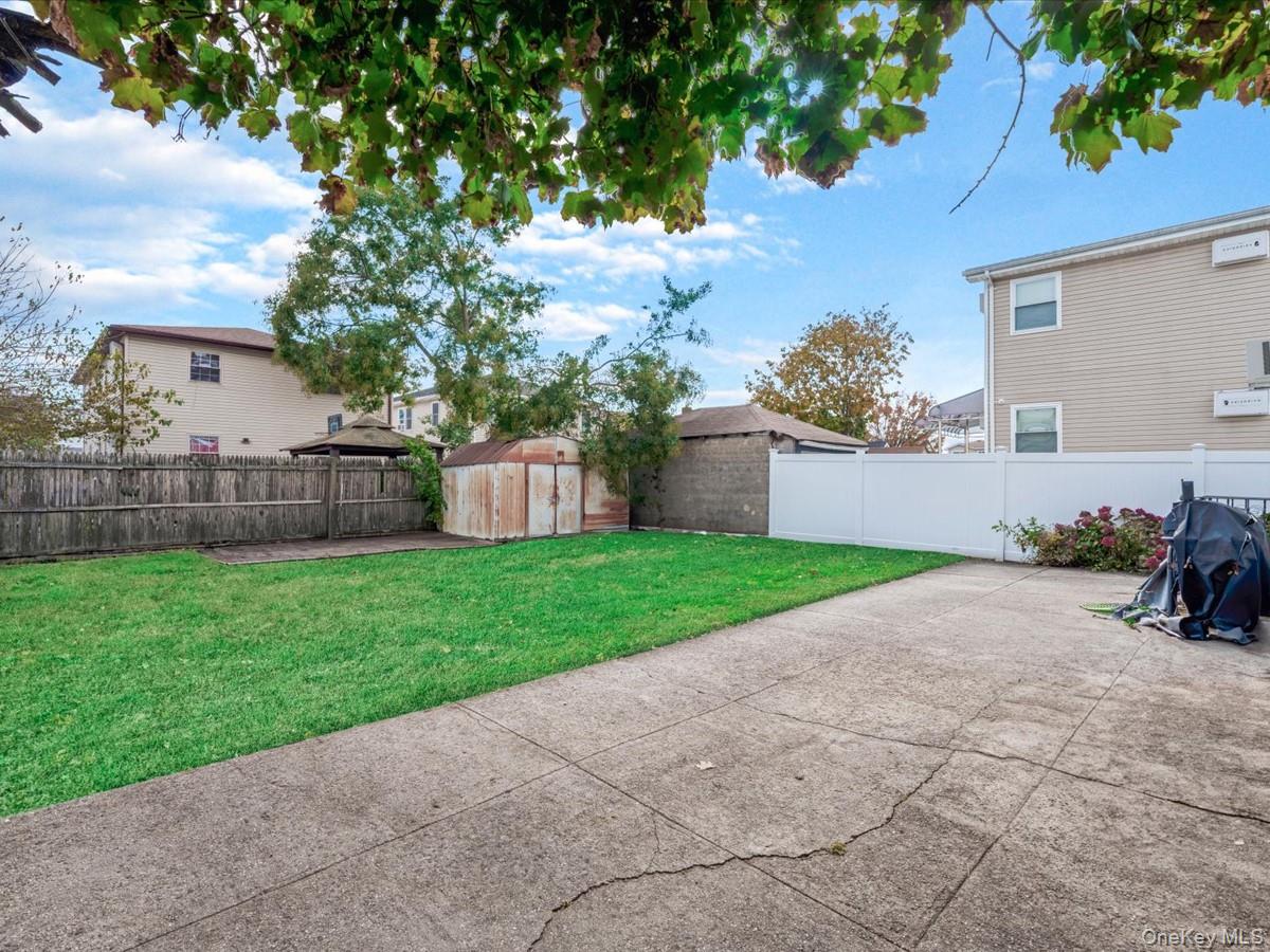 160-18 128th Avenue Queens, NY 11434 - Photo 4 of 5 a view of a house with a yard and a large tree