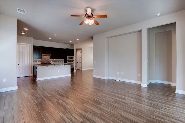 a view of kitchen with cabinets and wooden floor