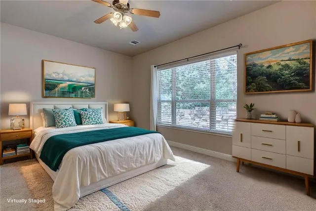 a bedroom with a large bed and a window