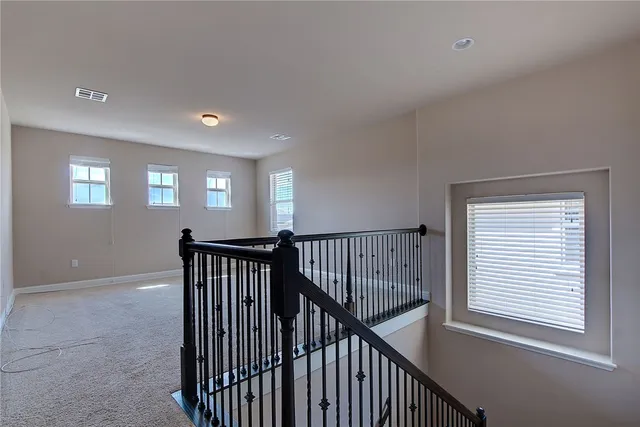 a view of hallway with windows and stairs