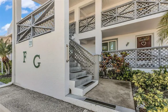 a view of a red door and chair in front of a house