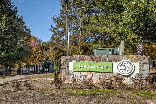 a view of a park with a bench and trees