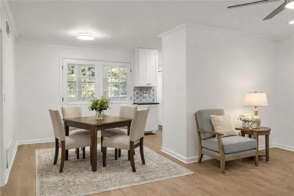 a kitchen with granite countertop white cabinets and white appliances