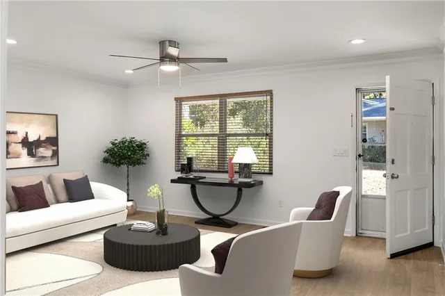 a living room with furniture a window and a potted plant