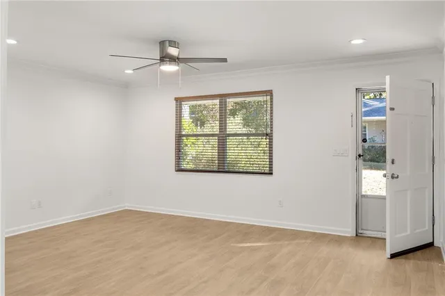 wooden floor in an empty room with a window