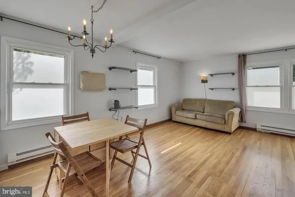 a living room with furniture and a chandelier