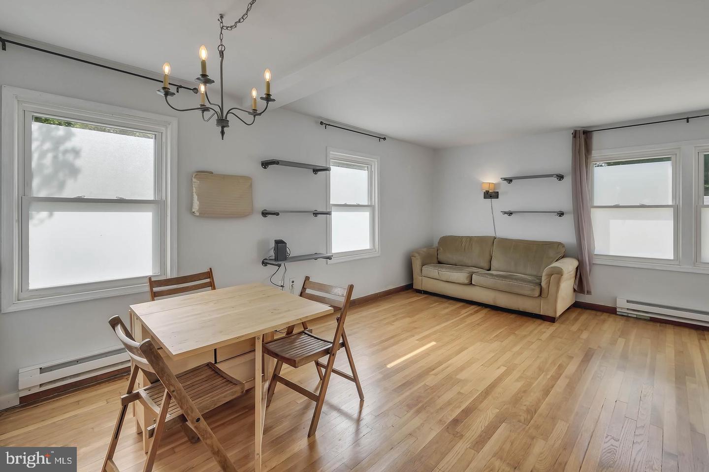 11 Hillside Road Greenbelt, MD 20770 - Photo 12 of 47 a living room with furniture and a chandelier