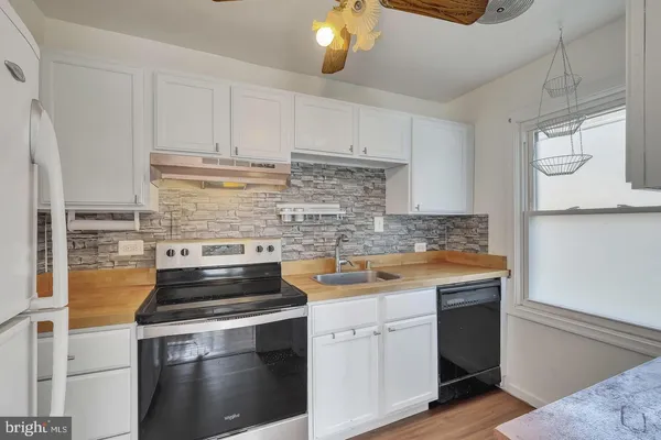 a kitchen with a stove and a sink
