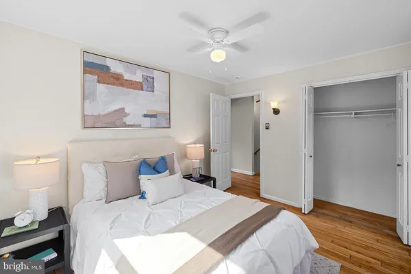 a bedroom with a bed and a painting on the wall